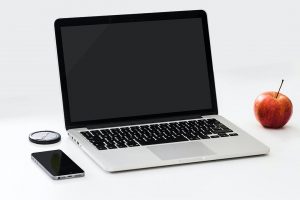 Laptop sitting on white desk about to displayRaiser's Edge Fundraising Software Tips for Beginner's blog