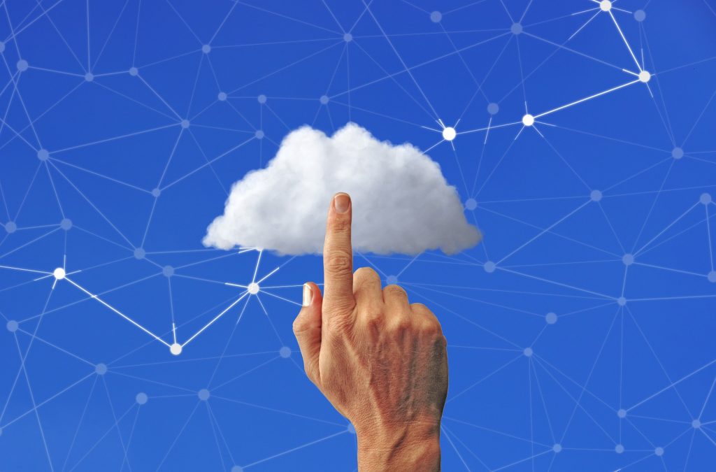A finger pointing to a white cloud over a blue background to show nonprofit cloud hosting